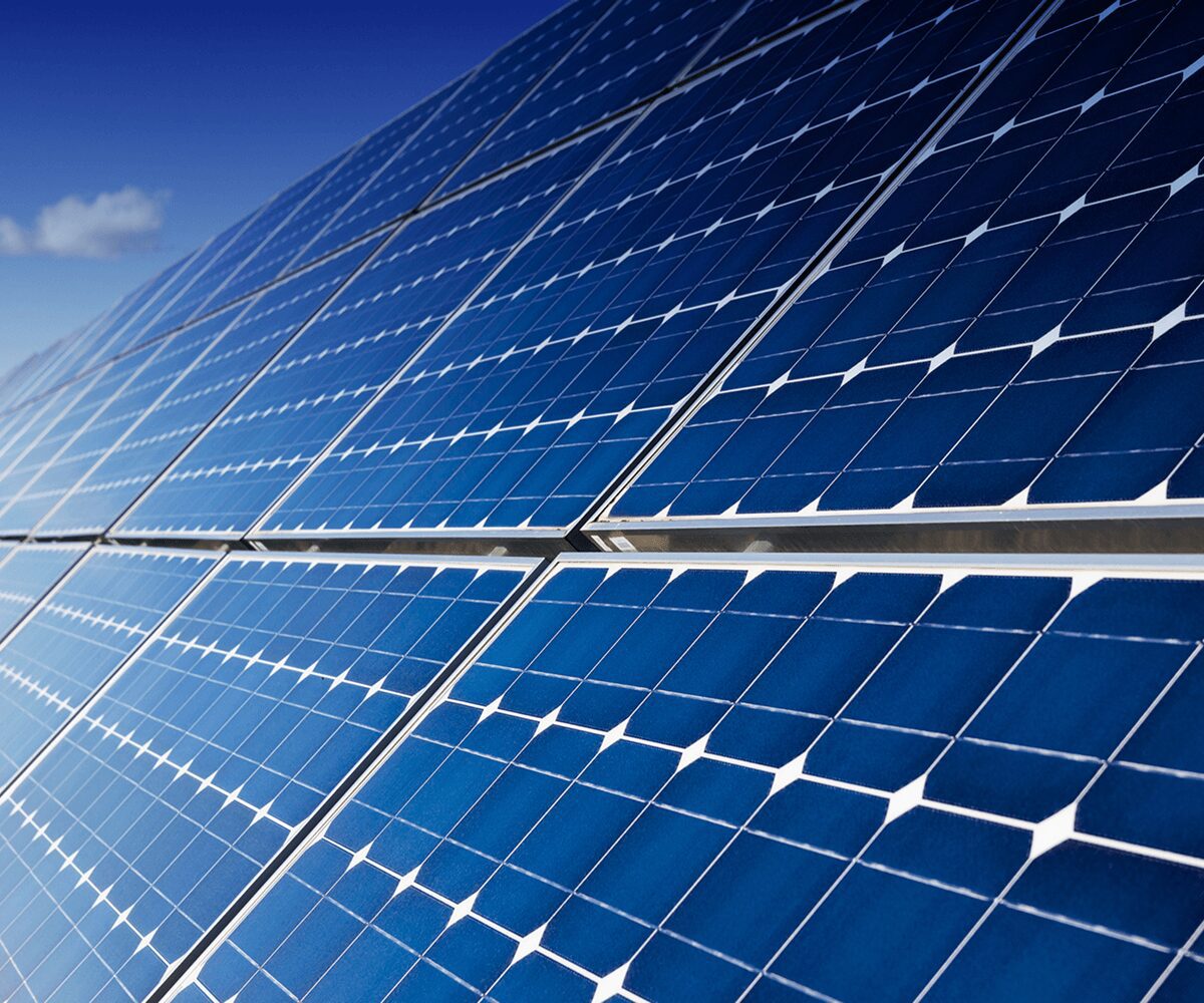 Solar panels under a clear blue sky.