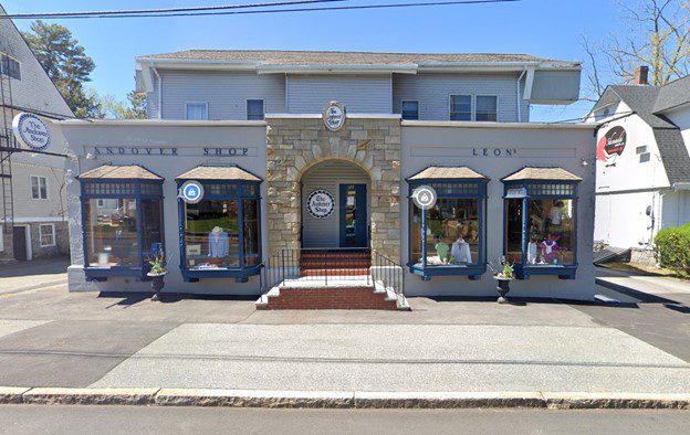 Classic two-story building with large display windows on each side of the entrance.