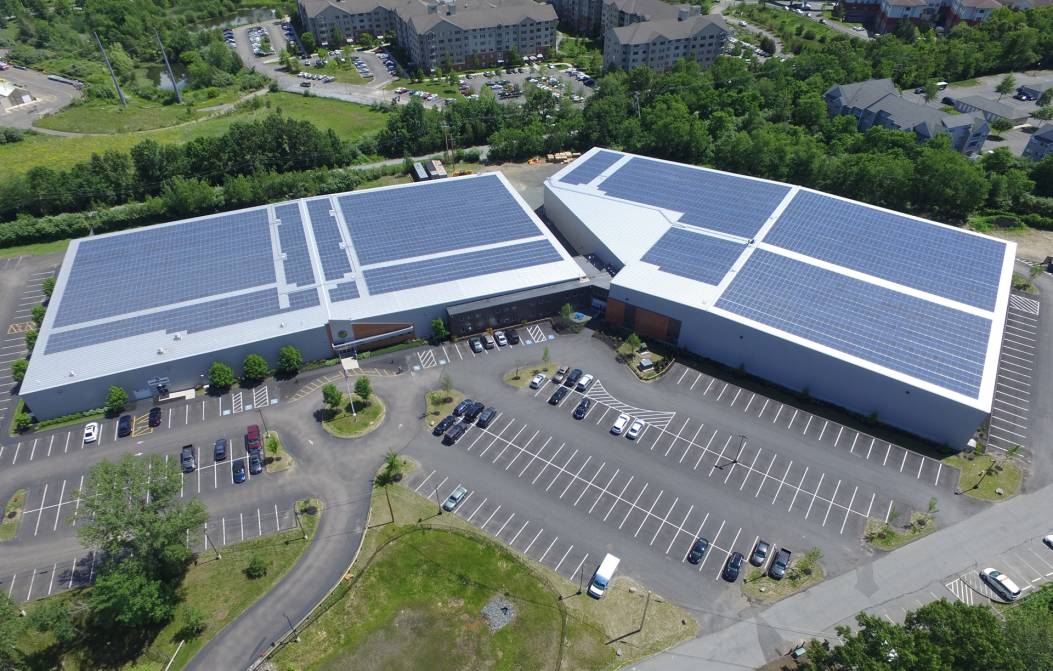 Aerial view of buildings with solar panels.