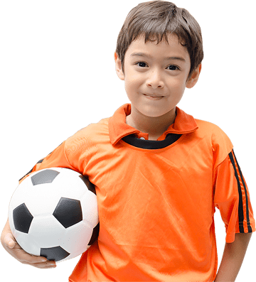 Child holding soccer ball, wearing orange jersey.