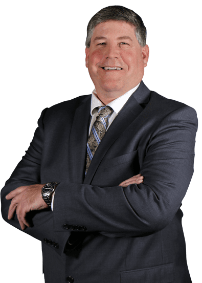 Smiling man in suit with crossed arms.